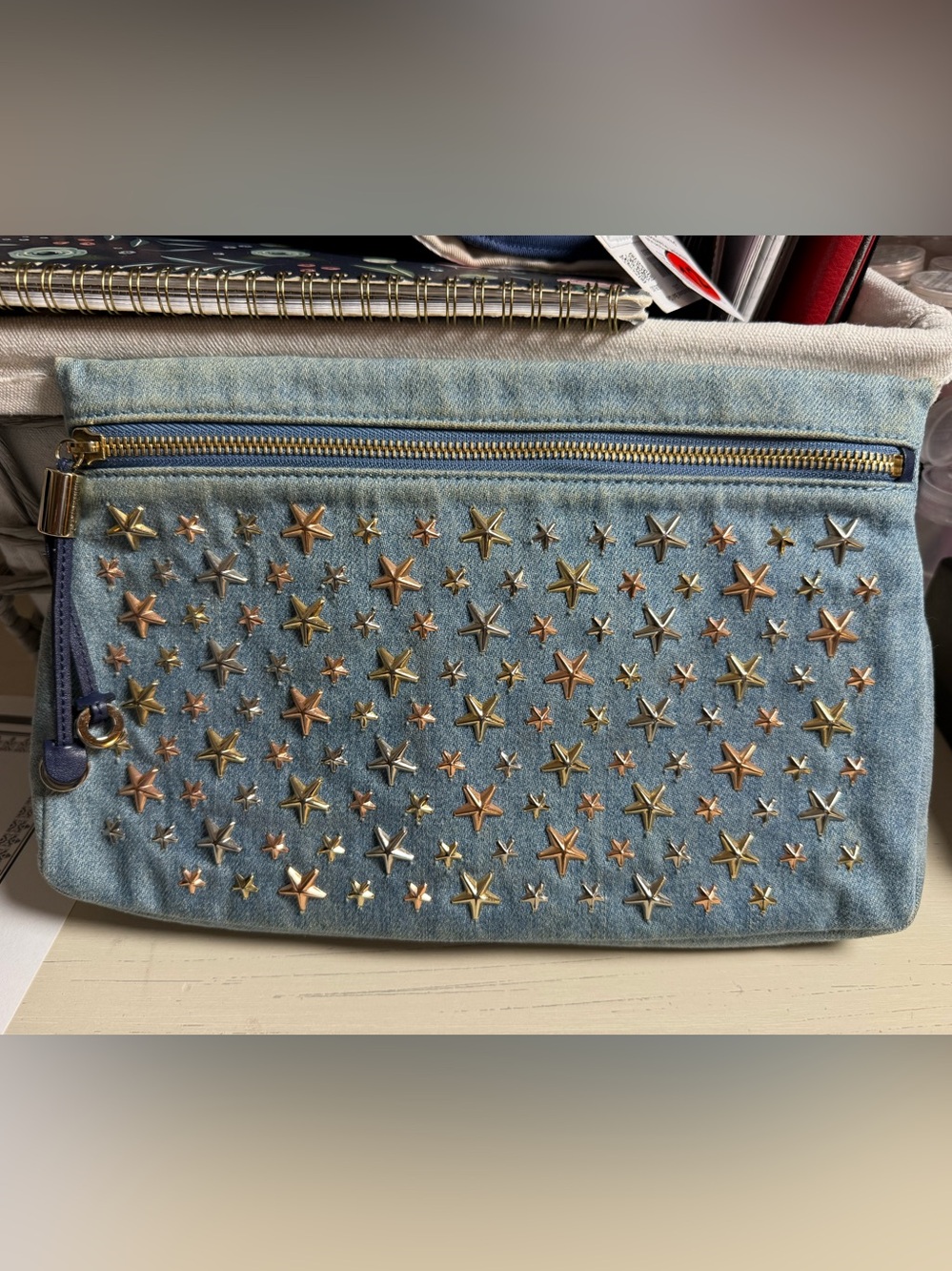 Jimmy Choo Zena denim clutch featuring mixed-metal star studs. Authentic